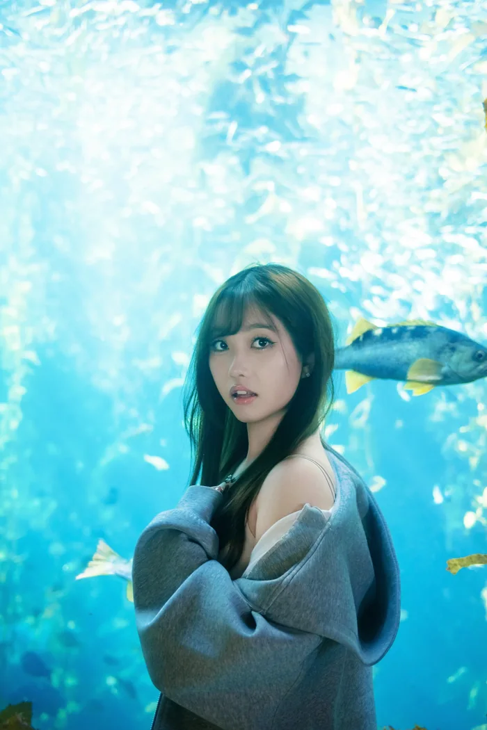 Aquarium shoot cover — portrait against a lit aquarium tank